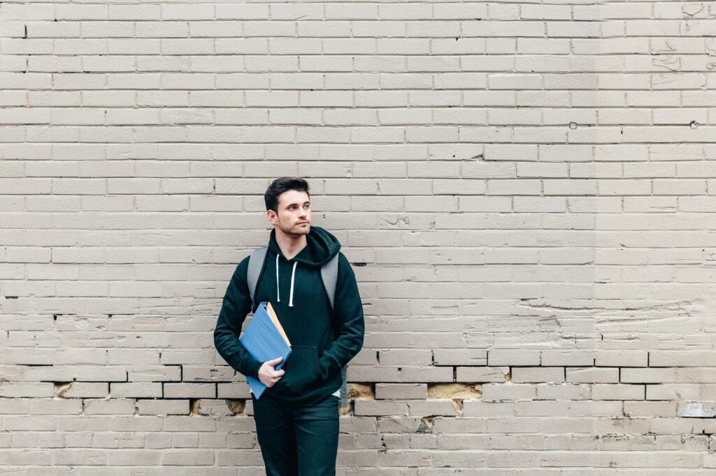 Avivo collection hero image featuring high school secondary student leaning against a wall holding tutoring resources